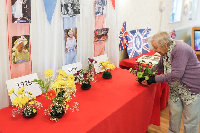 Vera Wren, 90, a resident of The Lawn care home in Alton, Hampshire, where residents have decorated a table with photographs of the Queen, bunting and their own flower arrangements (Friends of the Elderly/PA)